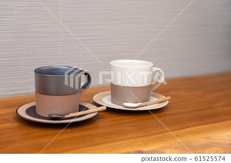 Pair of coffee cups and natural wood counter table 61525574