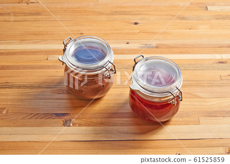 Textured wooden background an glass jar with jam 61525859