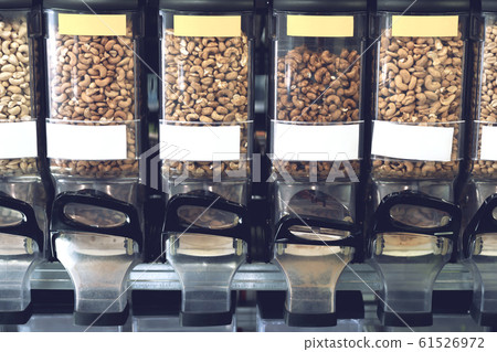 Dispensers with nuts in zero waste shop. New trend alternative buying. 61526972