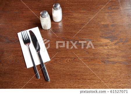 Silverware with salt and pepper on a rustic pub Silverware with salt and pepper on a rustic pub 61527071
