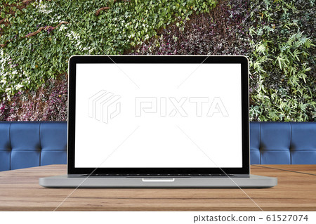 Laptop on wooden desk against ecological foliage Laptop on wooden desk against ecological foliage 61527074