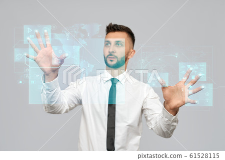 Smart businessman touching virtual 3D icon. Smart businessman touching virtual 3D icon. 61528115