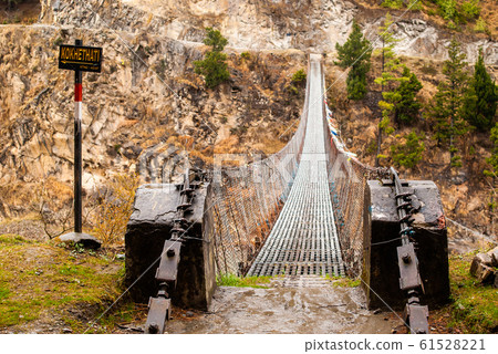 Picture of a suspension bridge over the mountain 61528221