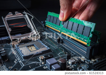 Electronic engineer of computer technology. Maintenance computer hardware upgrade of motherboard putting the Ram on the motherboard computer. Concept of PC memory upgrade. 61528313