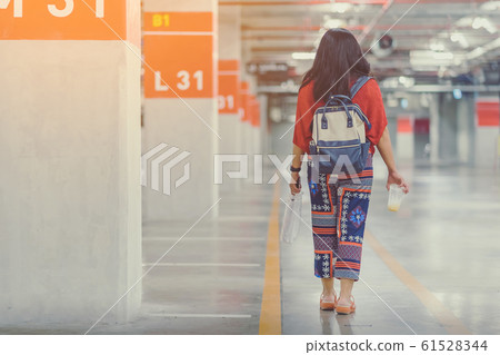A lonely Asian woman forgot and  can't find her car at underground parking after the mall is closed. 61528344