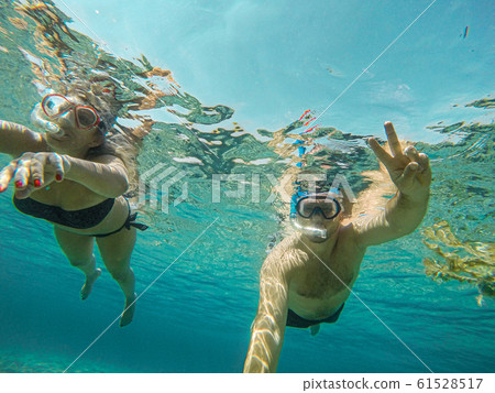 Young couple snorkeling selfie underwater camera on the coral reef in ocean of Egypt Hurghada travel concept vacation Young couple snorkeling selfie underwater camera on the coral reef in ocean of Egypt Hurghada travel concept vacation 61528517