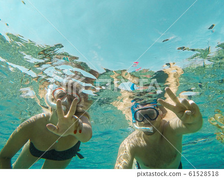 Young couple snorkeling selfie underwater camera on the coral reef in ocean of Egypt Hurghada travel concept vacation 61528518