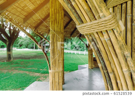 Many bamboo bindings are tied together with hemp ropes to be used as pole for resting cottage. Selective focus on hemp ropes. 61528539