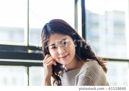 A woman sitting at the window 61528680
