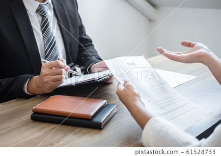 Employer or committee holding reading a resume Employer or committee holding reading a resume 61528733
