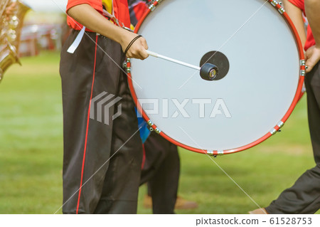 Marching band bass drummers perform in school parade Marching band bass drummers perform in school parade 61528753