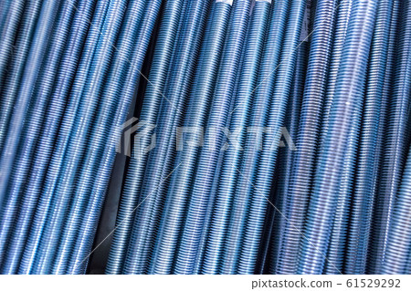 Threaded metal rods. Technological background or texture. A number of threaded steel rods, may be used as background. Threaded metal rods. Technological background or texture. A number of threaded steel rods, may be used as background. 61529292