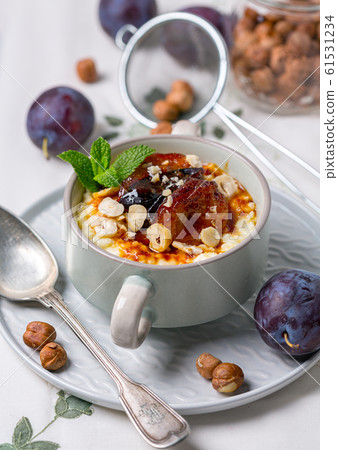 Gluten-free millet porridge in a ceramic bowl. 61531234