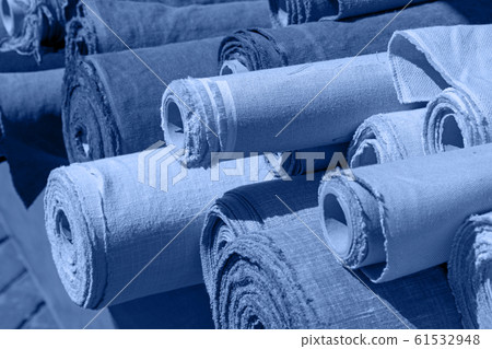 Blue toned rolls of linen canvas textile on market 61532948