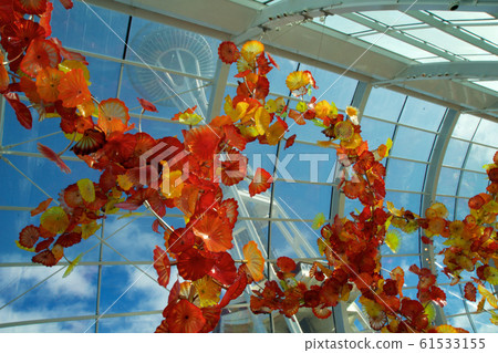 SEATTLE, WASHINGTON, USA - JAN 23rd, 2017: View of the Space Needle from inside the Chihuly Garden and Glass museum conservatory next door. Unique perspective. Reflections. Focus is on the glass SEATTLE, WASHINGTON, USA - JAN 23rd, 2017: View of the Space Needle from inside the Chihuly Garden and Glass museum conservatory next door. Unique perspective. Reflections. Focus is on the glass 61533155