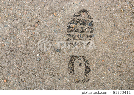 Wet footprint on asphalt surface. warning - thief Wet footprint on asphalt surface. warning - thief 61533411