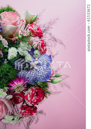 stylish trendy delicate bouquet with a variety of spring flowers, roses, orchids in a round box on a stylish trendy delicate bouquet with a variety of spring flowers, roses, orchids in a round box on a 61533672