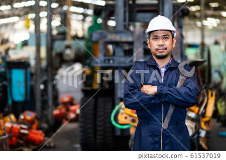 Portrait of Asian mechanic Fold over holding a maintenance tools Portrait of Asian mechanic Fold over holding a maintenance tools 61537019