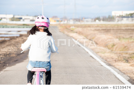 Children riding a bicycle 61539474
