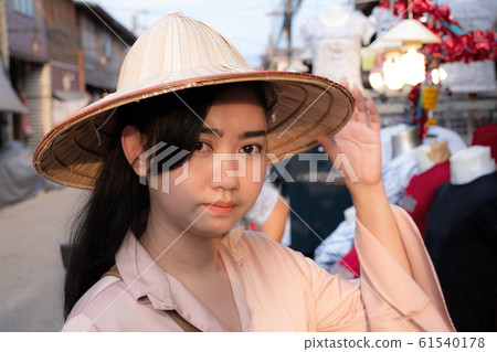 Portrait young beauty Asian woman wearing straw Vietnamese hat with smiley face Portrait young beauty Asian woman wearing straw Vietnamese hat with smiley face 61540178