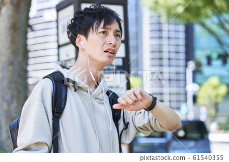 Young men waiting for bus Young men waiting for bus 61540355