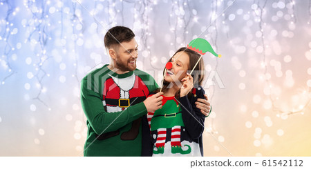 couple with christmas party props in ugly sweaters couple with christmas party props in ugly sweaters 61542112