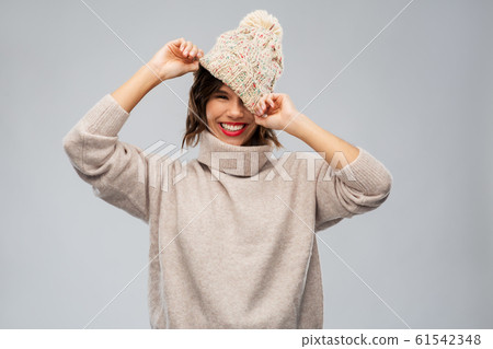 young woman in knitted winter hat and sweater young woman in knitted winter hat and sweater 61542348