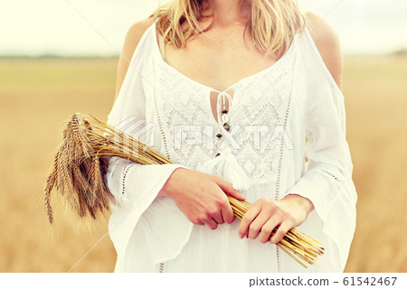 close up of happy woman with cereal spikelets 61542467