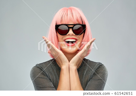 happy woman in pink wig and black sunglasses 61542651
