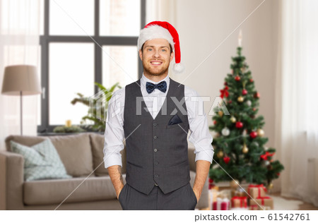 man in santa hat and suit at home on christmas man in santa hat and suit at home on christmas 61542761