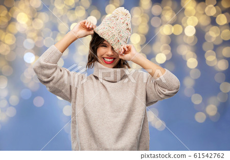 young woman in winter hat and sweater on christmas young woman in winter hat and sweater on christmas 61542762