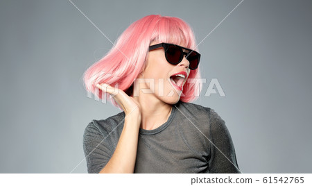 happy woman in pink wig and sunglasses dancing happy woman in pink wig and sunglasses dancing 61542765
