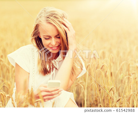 happy woman with smartphone and earphones happy woman with smartphone and earphones 61542988