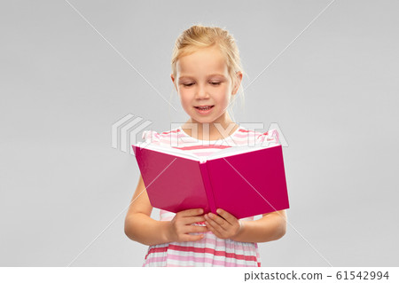smiling little girl reading book 61542994