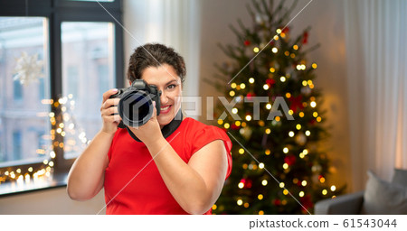 happy woman photographer with digital camera happy woman photographer with digital camera 61543044