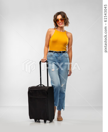 happy young woman in sunglasses with travel bag 61543045