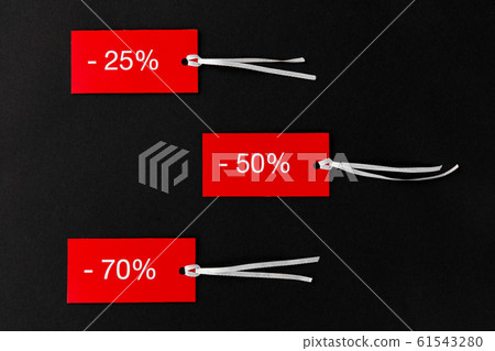 red tags with discount signs on black background red tags with discount signs on black background 61543280