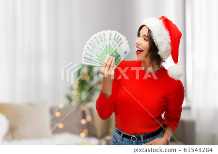 happy woman in santa hat with money on christmas happy woman in santa hat with money on christmas 61543284