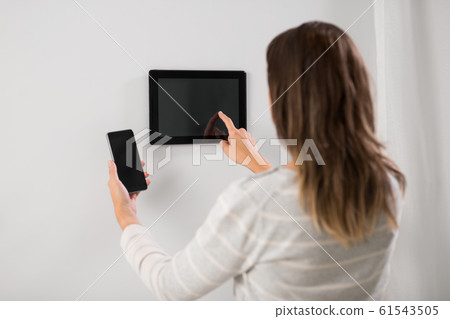 woman using tablet computer and smartphone woman using tablet computer and smartphone 61543505