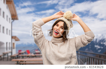 woman in winter hat and sweater at ski resort 61543628