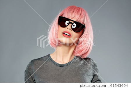 happy woman in pink wig and black sunglasses happy woman in pink wig and black sunglasses 61543694