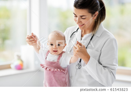 female pediatrician doctor with baby at clinic female pediatrician doctor with baby at clinic 61543823