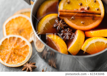 pot with hot mulled wine, orange slices and spices 61543846
