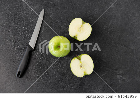 green apples and kitchen knife on slate background green apples and kitchen knife on slate background 61543959