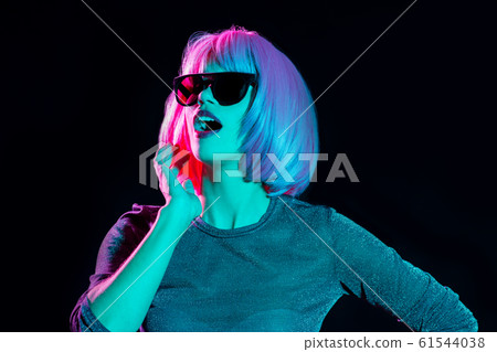 happy woman in pink wig and black sunglasses happy woman in pink wig and black sunglasses 61544038