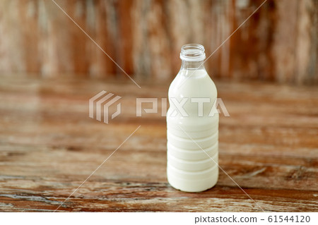 bottle of milk on wooden table bottle of milk on wooden table 61544120