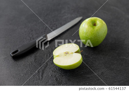 green apples and kitchen knife on slate background green apples and kitchen knife on slate background 61544137