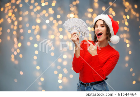 happy woman in santa hat with money on christmas happy woman in santa hat with money on christmas 61544464