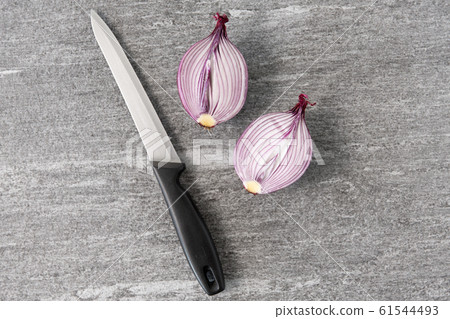 cut red onion and knife on slate stone background cut red onion and knife on slate stone background 61544493