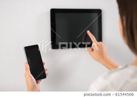 woman using tablet computer and smartphone 61544506